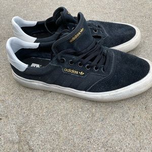 Adidas black sneakers with gold sign. Lots of life left.